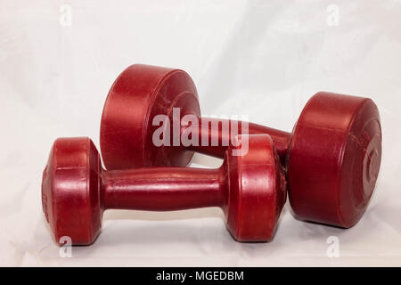 Red two and five pound hand weights for exercise Stock Photo