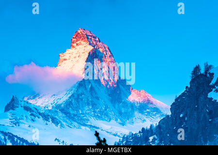 View of beautiful Matterhorn Peak with the golden glow of sunlight in the morning at Zermatt Village Switzerland Stock Photo