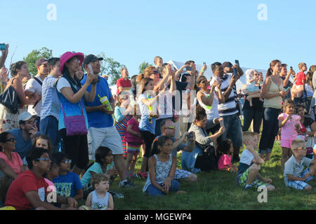 A crowd of onlookers photographing a balloon launch with a variety of handheld cameras,phones and tablets Stock Photo