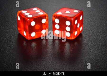 Red luminescent casino gambling dice on black background Stock Photo