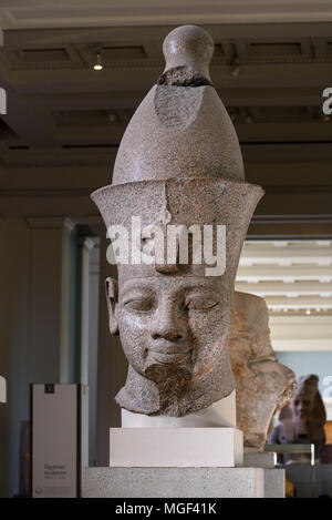 London. England. British Museum. Colossal red granite statue believed to be Egyptian Pharaoh Amenhotep III wearing a double crown (Pschent) Stock Photo