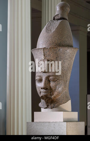 London. England. British Museum. Colossal red granite statue believed to be Egyptian Pharaoh Amenhotep III wearing a double crown (Pschent) Stock Photo