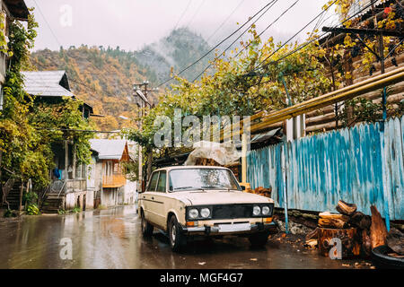 Borjomi, Samtskhe-Javakheti, Georgia - October 25, 2016:  Russian Old Rusty VAZ-2106 Lada Zhiguli Car Sedan Parking On Village Street In Rainy Autumn  Stock Photo