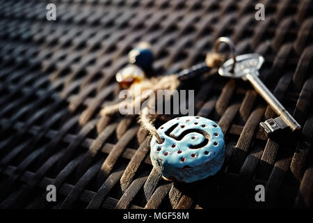 Authentic hotel room key chain on a straw table. Number five carved on it. Stock Photo