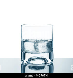 Glass of vodka with ice on a white background and reflective surface Stock Photo