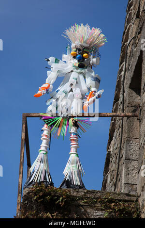 Upcycled, reused plastic sculpture figure in Wray, Lancaster, UK. Items made from recycled plastic;   Sculpting with pieces of plastic straws at the Wray Scarecrow Festival and Fair. The villagers of Wray are back again to creating some weird figures, wacky portraits and wonderful creations made from discarded plastic milk bottles & everday cartons. Stock Photo