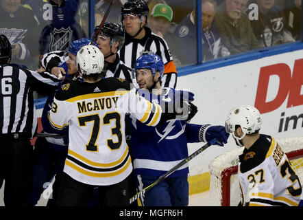 Boston Bruins defenseman Charlie McAvoy (73) is helped off the ice after  being hurt crashing into the dasher during the third period of an NHL  hockey game against the Tampa Bay Lightning