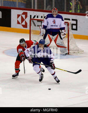 Budapest, Hungary. 28 April 2018. (l-r) Csanad Erdely of Hungary challenges Dallas Ehrhardt of Great Britain in front of Ben Bowns of Great Britain during the 2018 IIHF Ice Hockey World Championship Division I Group A match between Hungary and Great Britain at Laszlo Papp Budapest Sports Arena on April 28, 2018 in Budapest, Hungary. Credit: Laszlo Szirtesi/Alamy Live News Stock Photo