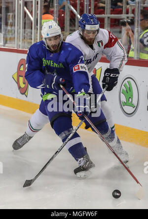 Budapest, Hungary. 28th Apr, 2018. Italy's Thomas Larkin (R) vies with Slovenia's Bostjan Golicic during the Division I Group A match between Italy and Slovenia at the 2018 IIHF Ice Hockey World Championship in Budapest, Hungary, on April 28, 2018. Italy won 4-3. Credit: Csaba Domotor/Xinhua/Alamy Live News Stock Photo
