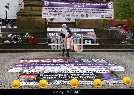 Manchester, Lancashire, UK. 28th Apr, 2018. A relative of a deceased UK construction worker reads his story at the International Workers Memoriial Day rally in Manchester city centre. This day (April 28th) each year commemorates all workers killed, injured or made ill by work. Credit: Andrew Mccoy/SOPA Images/ZUMA Wire/Alamy Live News Stock Photo
