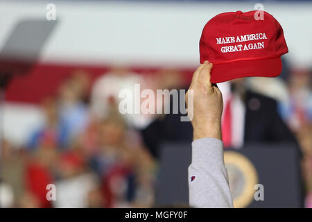 Michigan, USA . 28th Apr, 2018. A supporter seen raising a caps writting on it 'Make America Great Again' while the President Donald Trump gives a speech during a campaign rally in Washingtown Township, Michigan. Credit: SOPA Images Limited/Alamy Live News Stock Photo