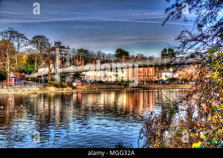 City of Chester, England. Artistic view of Queens Park Suspension Bridge over the River Dee, with the Groves promenade in the background. Stock Photo