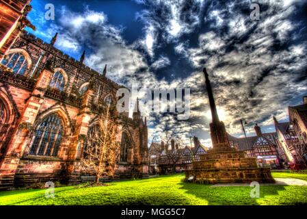 City of Chester, England. Artistic view of the memorial cross in Chester Cathedral’s southern garden, with St Werburgh Street in the background. Stock Photo