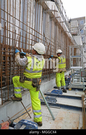 Construction of the new extension to Brighton's Royal Sussex Hospital. Shows workmen assembling steel reinforcement for concrete basement walls.. Stock Photo