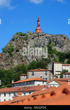 The iron statue of Notre-Dame de France (The Virgin Mary) overlooks the rooftops of Le-Puy-en-Velay, Haute-Loire, France Stock Photo