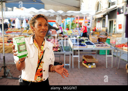 A vendor shows a bag of Le Puy green lentils at the local fruit and veg market in the city of Le-Puy-en-Velay, France Stock Photo
