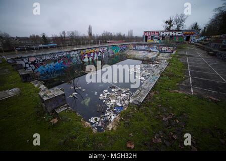 Historic abandoned swimming pools in Compiegne, France. The ancient baths have been left to decay and gather graffiti. Stock Photo