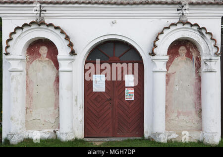 Saints Peter and Paul depicted in the mural paintings next to the entrance to the Romanesque church of Saints Peter and Paul from late 12th century at the village cemetery in Albrechtice nad Vltavou in South Bohemian Region, Czech Republic. Stock Photo