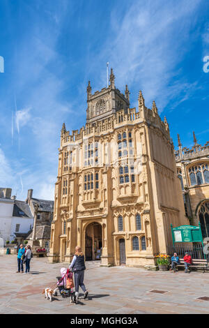 The Parish Church of St. John the Baptist lights up in the afternoon sunshine on a beautiful spring day in the old Roman town of Cirencester (Corinium Stock Photo