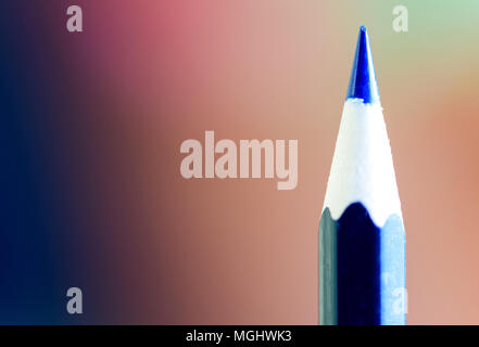 Sharp point of a blue pencil with a defocused background and copy space area for education drawing based ideas and designs Stock Photo