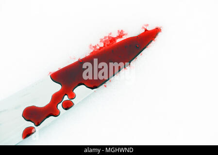 Sharp metal kitchen knife edge used as a violent murder weapon with blood drops on a white snow background. Blade covered in violence with copy space 