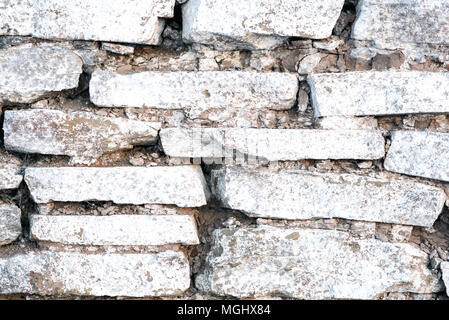 Old stacked tile wall with white wash paint in an old worn state Stock Photo