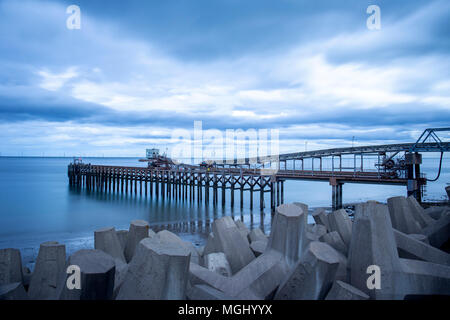 Raynes Quarry and jetty with sea defence in Llanddulas North Wales UK Stock Photo