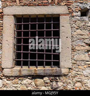 The broken window on stone wall, for background Stock Photo