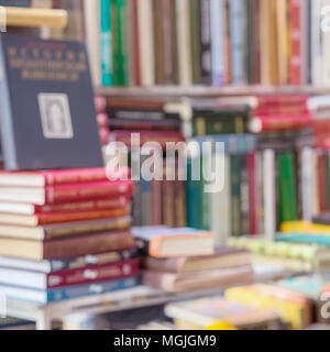 Many books, textbooks or fiction in rows lying on the table, on the shelves in library or in modern urban bookshop. Self-study, educational, manuals,  Stock Photo
