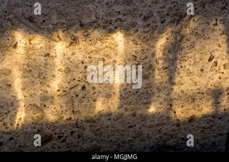 bright sunbeam on a rough concrete wall Stock Photo
