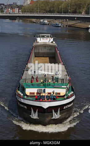 Bremen, Germany - April 27th, 2018 - Front view of an inshore vessel on the river Weser heading directly towards the viewer