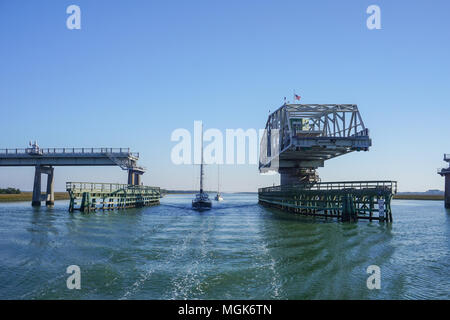 Atlantic Intracoastal Waterway, United States - two sailboats motor through an open highway swing bridge in Charleston, South Carolina Stock Photo