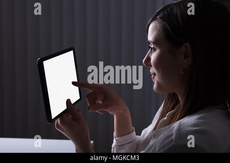 Woman Using Digital Tablet With Blank White Screen Stock Photo