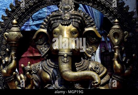 Close up of a brass statue of the Hindu God Ganesha with rich detail, tones and textures Stock Photo