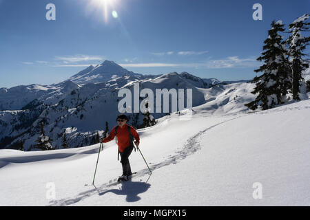Adventurous man is snowshoeing in the alpine. Taken in Artist Point, Northeast of Seattle, Washington, United States of America. Stock Photo