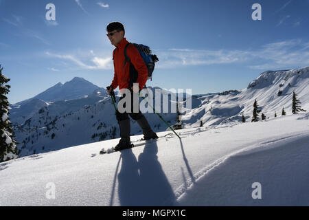 Adventurous man is snowshoeing in the alpine. Taken in Artist Point, Northeast of Seattle, Washington, United States of America. Stock Photo