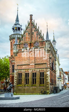 This city hall is one of the beautiful historical brick buildings with gargoyles and towers in the historic city of Kampen in the Netherlands Stock Photo