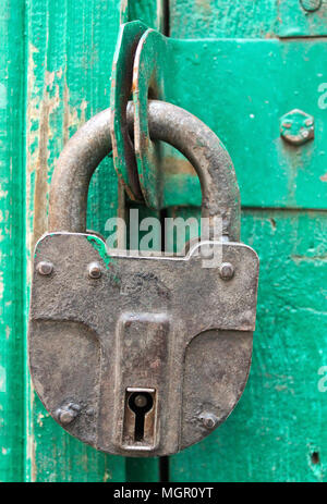 Padlock hanging on a wooden barn door Stock Photo
