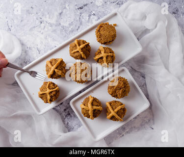 Hot Cross Muffins for Easter, brightly lit table scene Stock Photo
