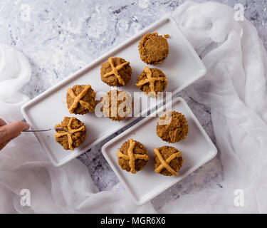 Hot Cross Muffins for Easter, brightly lit table scene Stock Photo