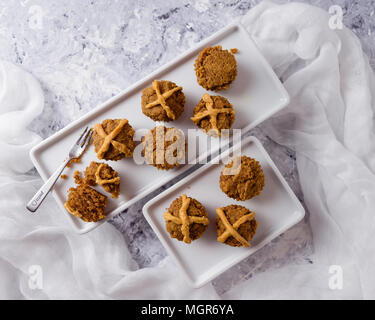 Hot Cross Muffins for Easter, brightly lit table scene Stock Photo
