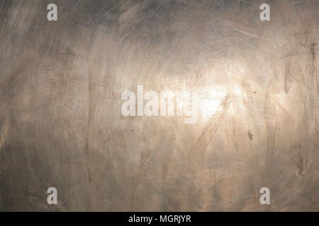 Bright shot of sunlight reflection on brushed metal surface. Stock Photo