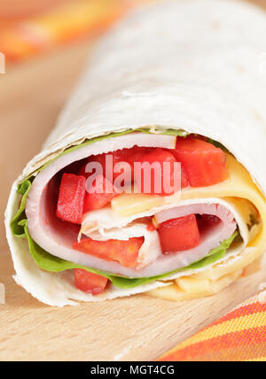 Ham and cheese tortilla roll-up with tomato closeup Stock Photo