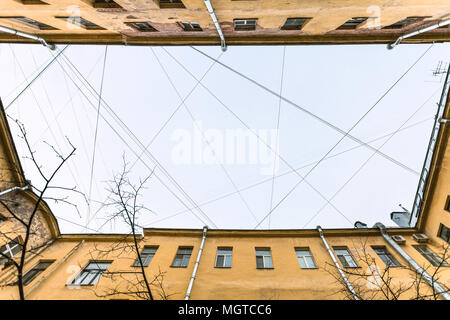 bottom view of many electrical wires and cables over urban yard in Saint Petersburg city in Saint Petersburg city in spring morning Stock Photo