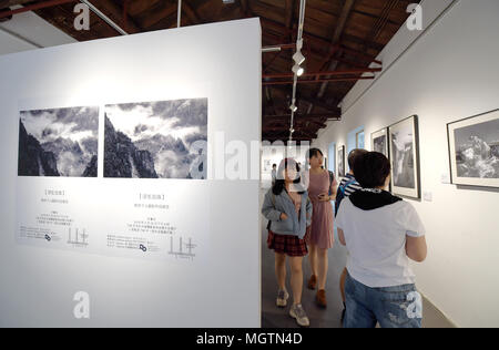 Beijing, China. 29th Apr, 2018. Tourists visit a photography exhibition at 798 ArtDist site in Beijing, capital of China, April 29, 2018. People in China spend their Labor Day holiday in various ways. Credit: Dai Tianfang/Xinhua/Alamy Live News Stock Photo