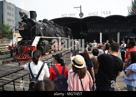 Beijing, China. 29th Apr, 2018. Tourists are seen at 798 ArtDist site in Beijing, capital of China, April 29, 2018. People in China spend their Labor Day holiday in various ways. Credit: Dai Tianfang/Xinhua/Alamy Live News Stock Photo
