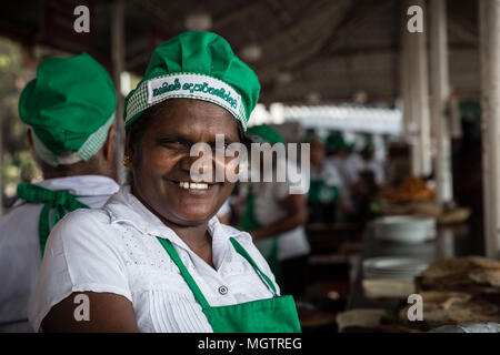 Kandy, Sri Lanka. 14th Feb, 2018. ANOMA DAMAYANSHI smiles while working at the Hela Bojun KCC cafÅ½ in central Kandy, Sri Lanka, on Wednesday, February 14, 2018.DAMAYANSHI, age 53, has worked. at the Hela Bojun KCC cafÅ½ in central Kandy for four years. She is married and has two children: a daughter, age 35 and a son, age 20. The Ministry of Agriculture initiated food stalls called Ã”Hela Bojun' islandwide with two intentions in mind: promoting local produce and empowering women. Credit: Tracy Barbutes/ZUMA Wire/Alamy Live News Stock Photo