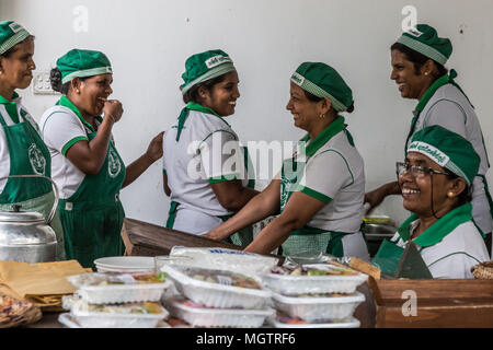 Kandy, Sri Lanka. 15th Feb, 2018. WASANTHA MENIKE, standing, second from right, jokes with her Hela Bojun Hala coworkers in the Kundasale suburb of Kandy, Sri Lanka, on Thursday, February 15, 2018.Wasantha worked in Saudi Arabia 10 years as housemaid, providing the sole income for her family. She continues to be the family's sole provider, currently working at the cafÅ½ from 6:30 in the morning until approximately 1:00pm each week day. She has two children, ages 18 and 20. Hela Bojun food courts, scattered throughout the country, are open kitchens that serve traditional Sri Lankan fo Stock Photo