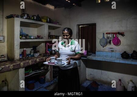 Kandy, Sri Lanka. 15th Feb, 2018. WASANTHA MENIKE prepares tea for her family in their rural home following her shift at the Hela Bojun Hala in the Kundasale suburb of Kandy, Sri Lanka, on Thursday, February 15, 2018.Wasantha worked in Saudi Arabia 10 years as housemaid, providing the sole income for her family. She continues to be the family's sole provider, currently working at the cafÅ½ from 6:30 in the morning until approximately 1:00pm each week day. She has two children, ages 18 and 20. Hela Bojun food courts, scattered throughout the country, are open kitchens that serve tradit Stock Photo
