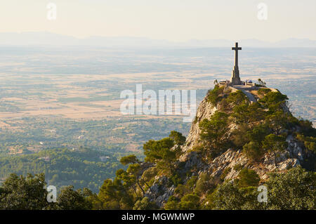 Panoramic view from Sant Salvador Sanctuary showing monolith cross, Majorca plains and Serra de Tramontana in the background (Felanitx, Majorca,Spain) Stock Photo